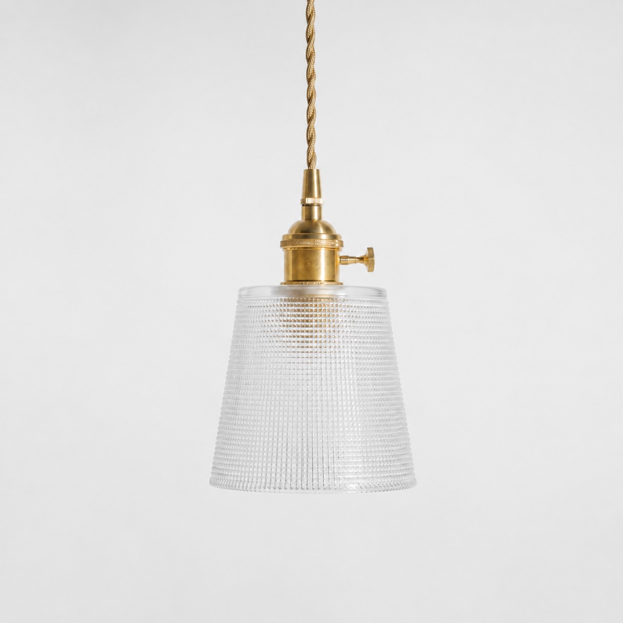 Style B textured glass shade with antique brass E27 socket, front view