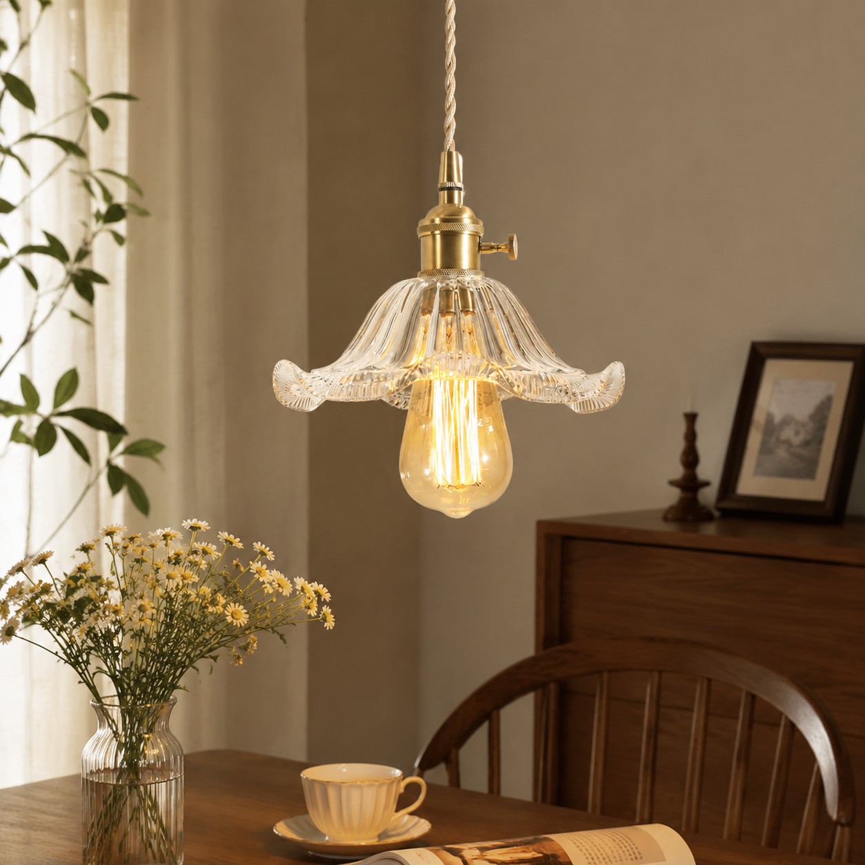Style N flower-edged clear glass pendant above a dining table
